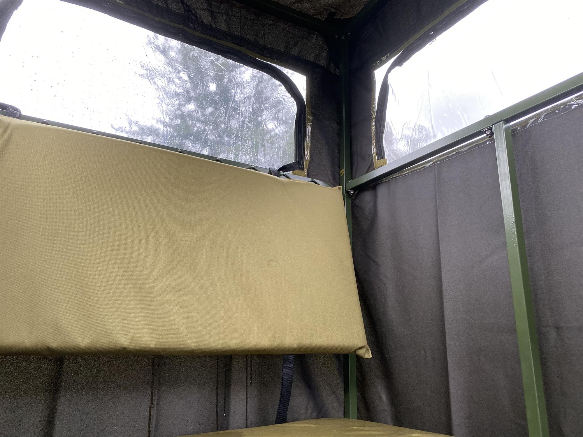 Covered double free-standing high seat hunting tower by DALE with water-resistant cover, enclosed design, ideal for hunting and wildlife observation.