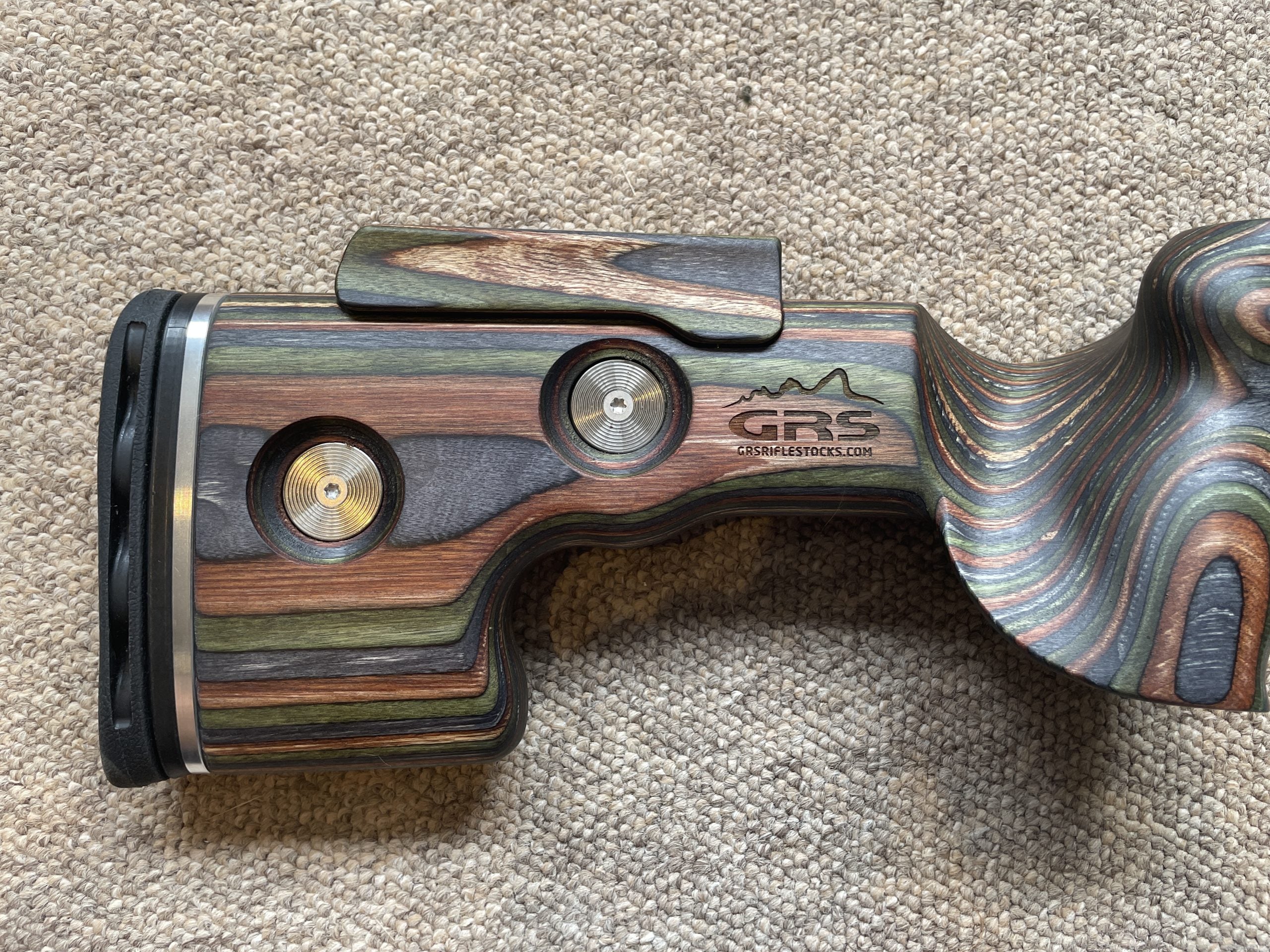 HIGHLAND GRS Sporter Standard Action rifle with Green Mountain Camo finish, designed for Blaser R8, shown in a natural outdoor setting.