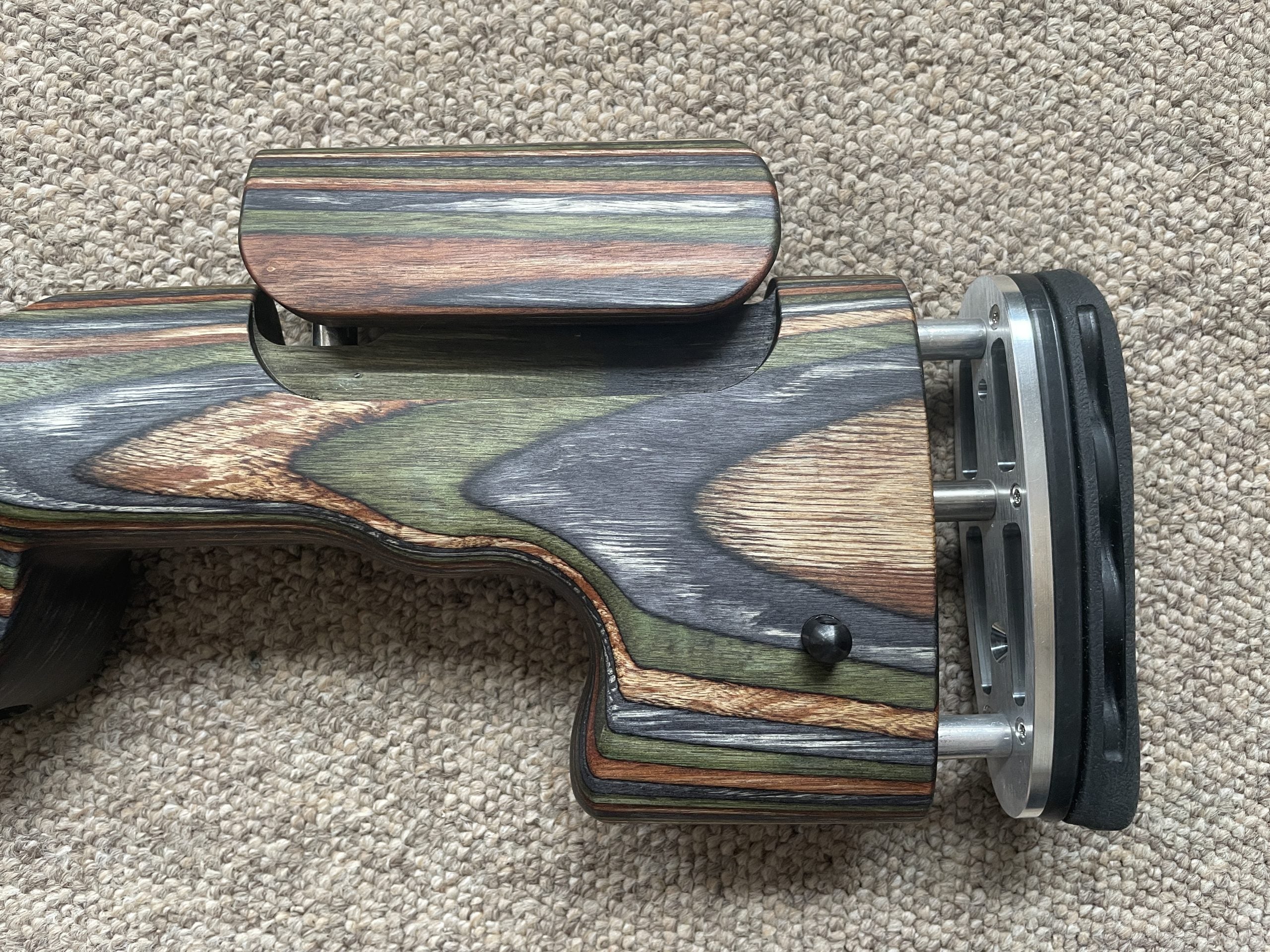 HIGHLAND GRS Sporter Standard Action rifle with Green Mountain Camo finish, designed for Blaser R8 model, shown in a natural outdoor setting.