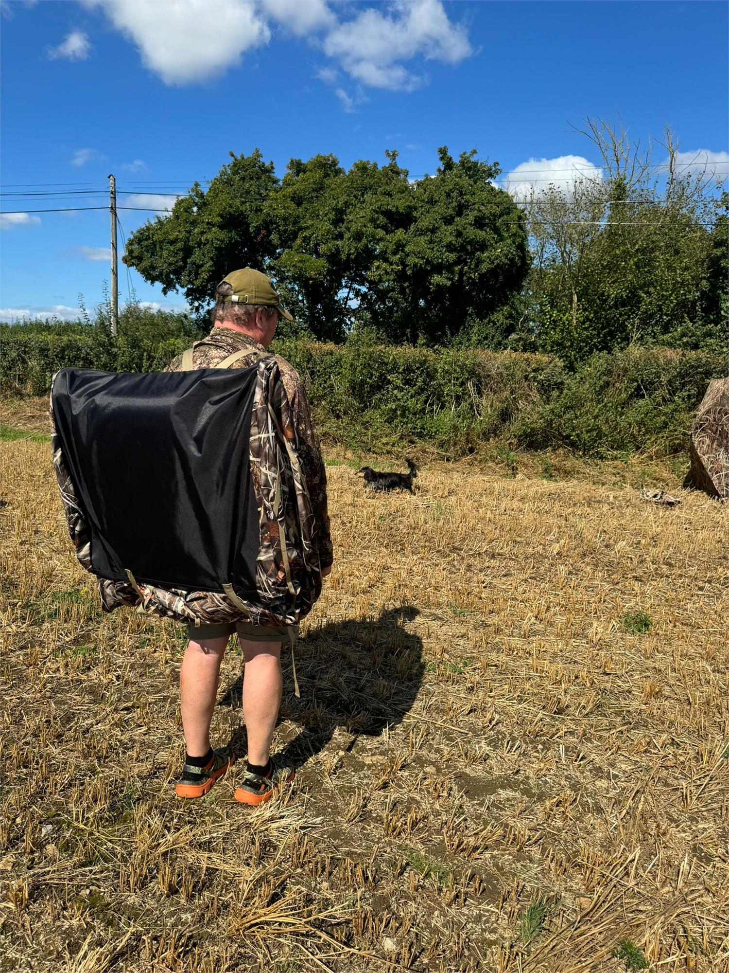 DALE Pop Up Wildfowl Stubble Camo Lay Down Ground Blind set up in a natural outdoor environment, designed for hunting concealment