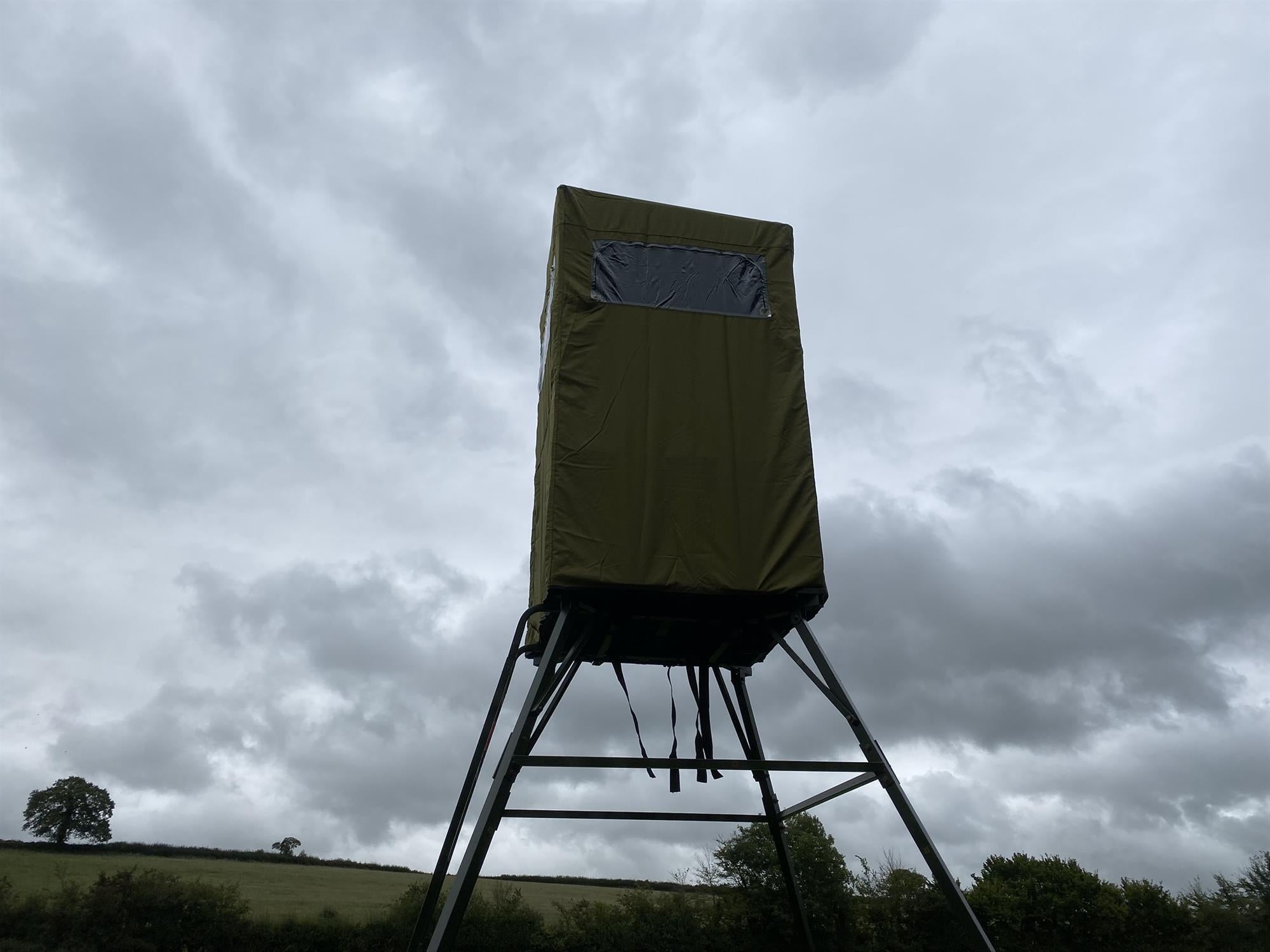 Covered double free-standing high seat by DALE, enclosed hunting tower with water-resistant cover for outdoor wildlife observation.