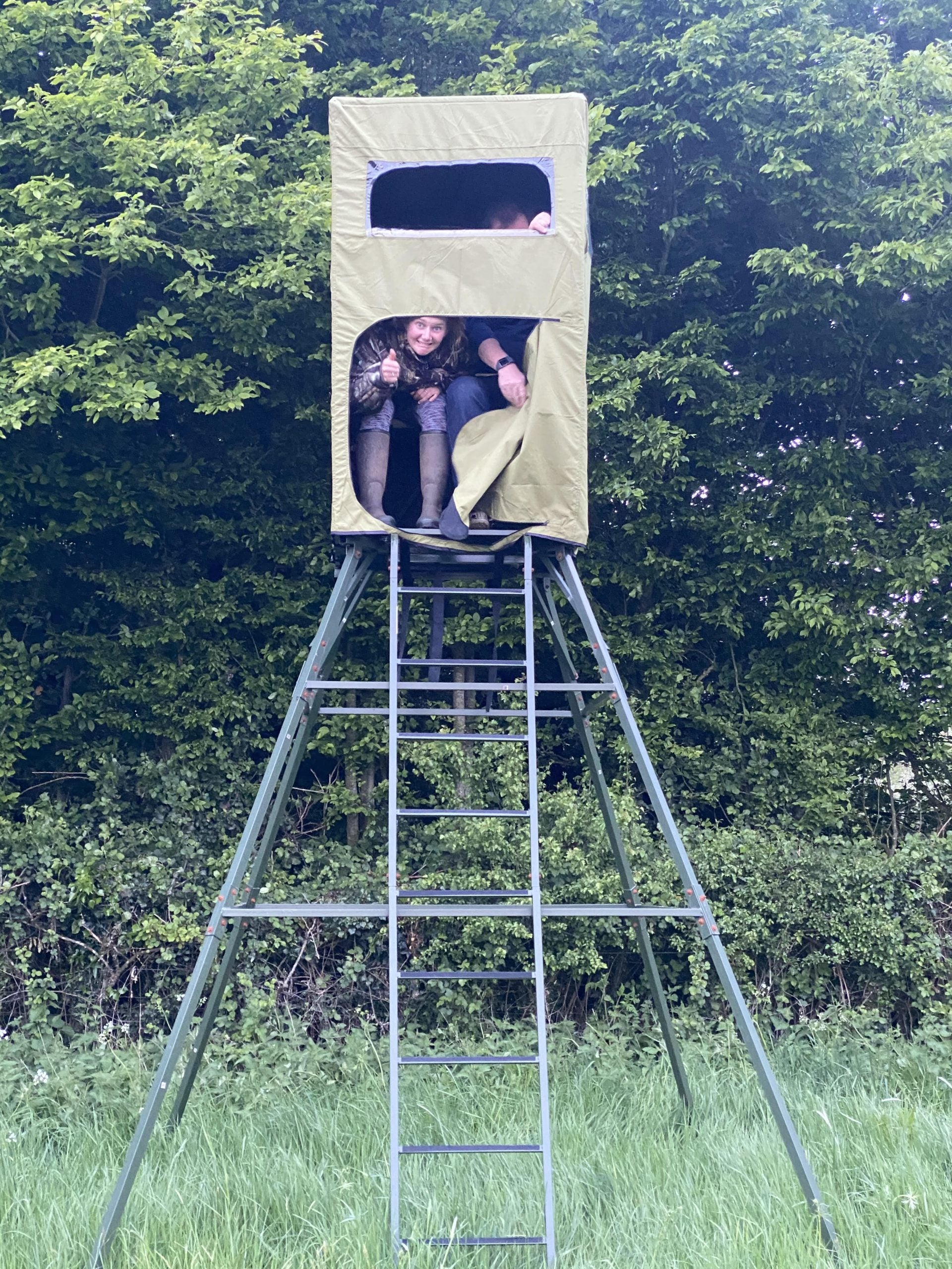 Covered double free-standing hunting tower high seat by DALE with water-resistant cover, enclosed design, ideal for hunting or wildlife viewing.