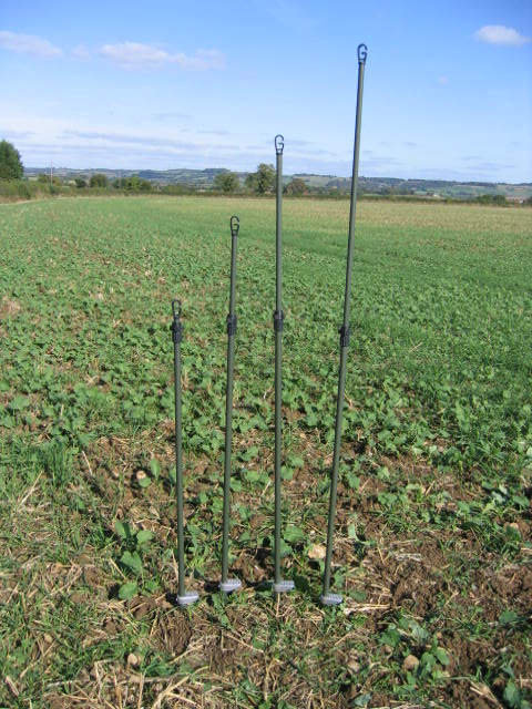Echo heavy duty hide poles kit with four green durable poles for outdoor hunting or trapping setups.