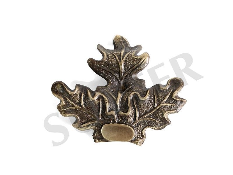 Silver, bronze, or gold leaf for trophy plates by SPJAGD, shown on decorative trophy plaques with metallic finishes.