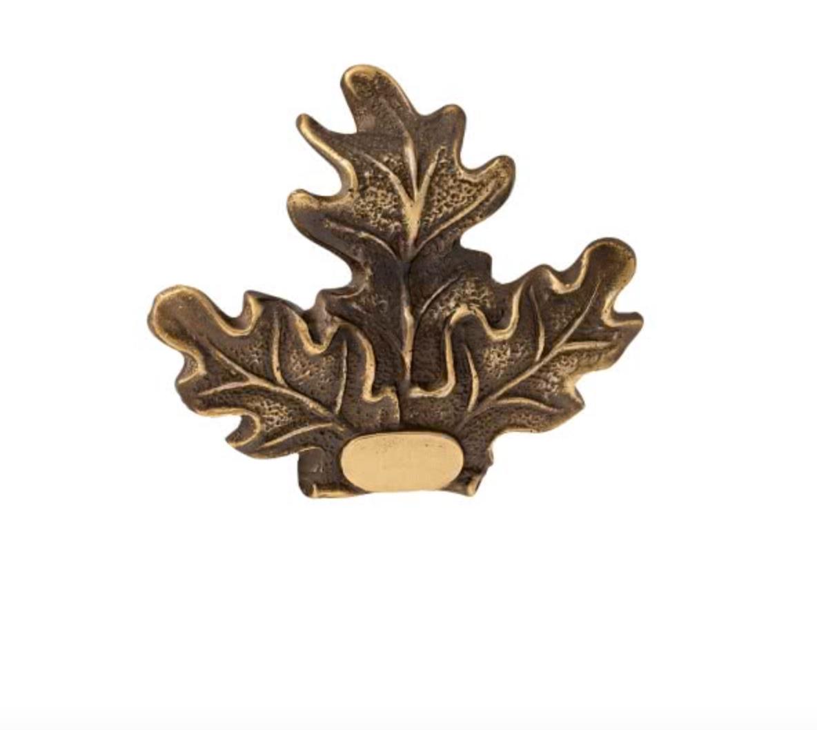 Silver, bronze, or gold leaf for trophy plates by SPJAGD, shown on a decorative trophy plate with metallic finish details.