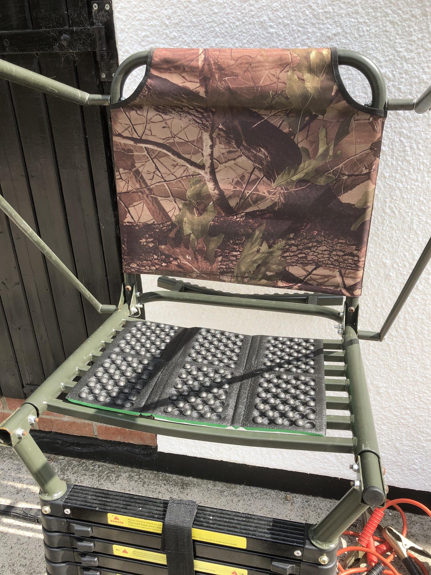 Green padded waterproof folding cushion for high seats or hunting, designed for comfort and durability during outdoor activities.