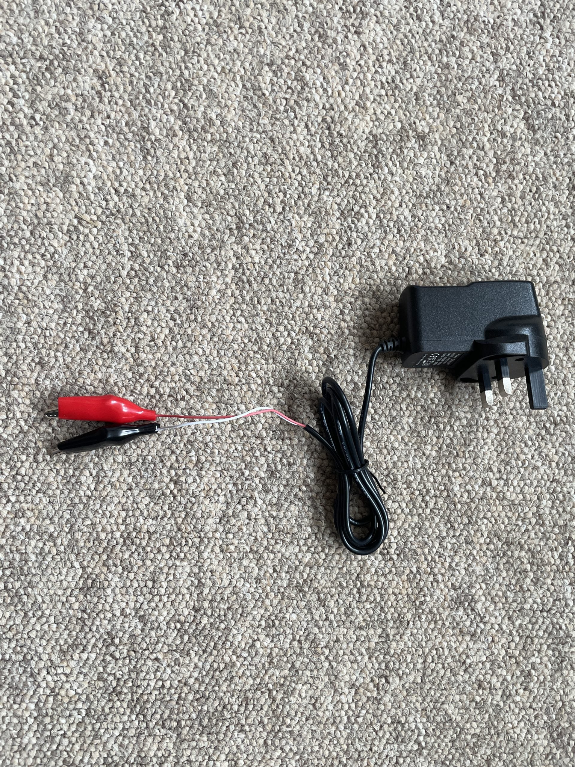 Monica 6V battery charger with croc clip terminals for easy connection to small batteries.