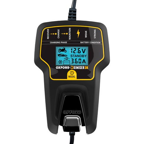 Oxford Oximiser 3X charger by A1 Decoy Ltd, shown connected to a device with USB ports and indicator lights.