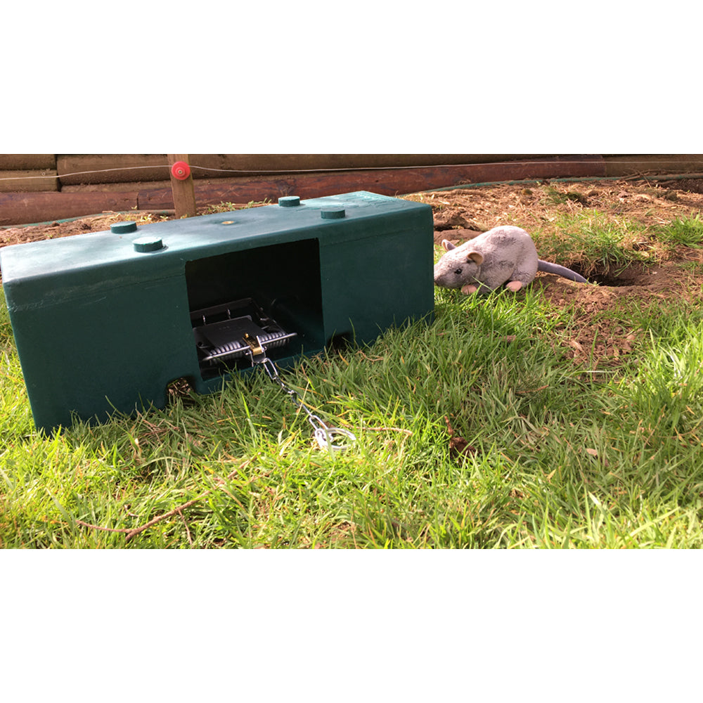 QUILL FEN TRAP MK 4 and vermin box used for pest control, showing the trap and box setup in an outdoor environment.