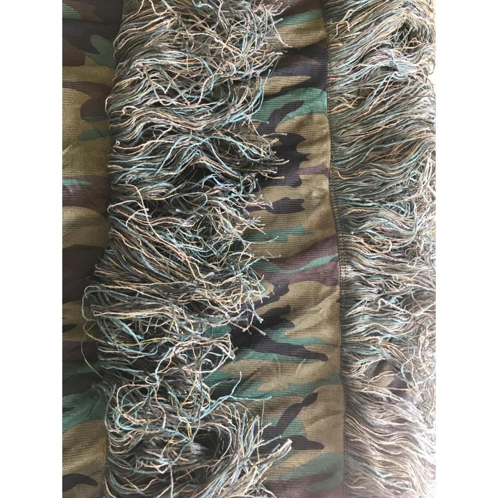 SIMON Ghillie Hide Camo Netting, camouflage netting for concealment, shown in outdoor setting with detailed leaf and branch pattern.