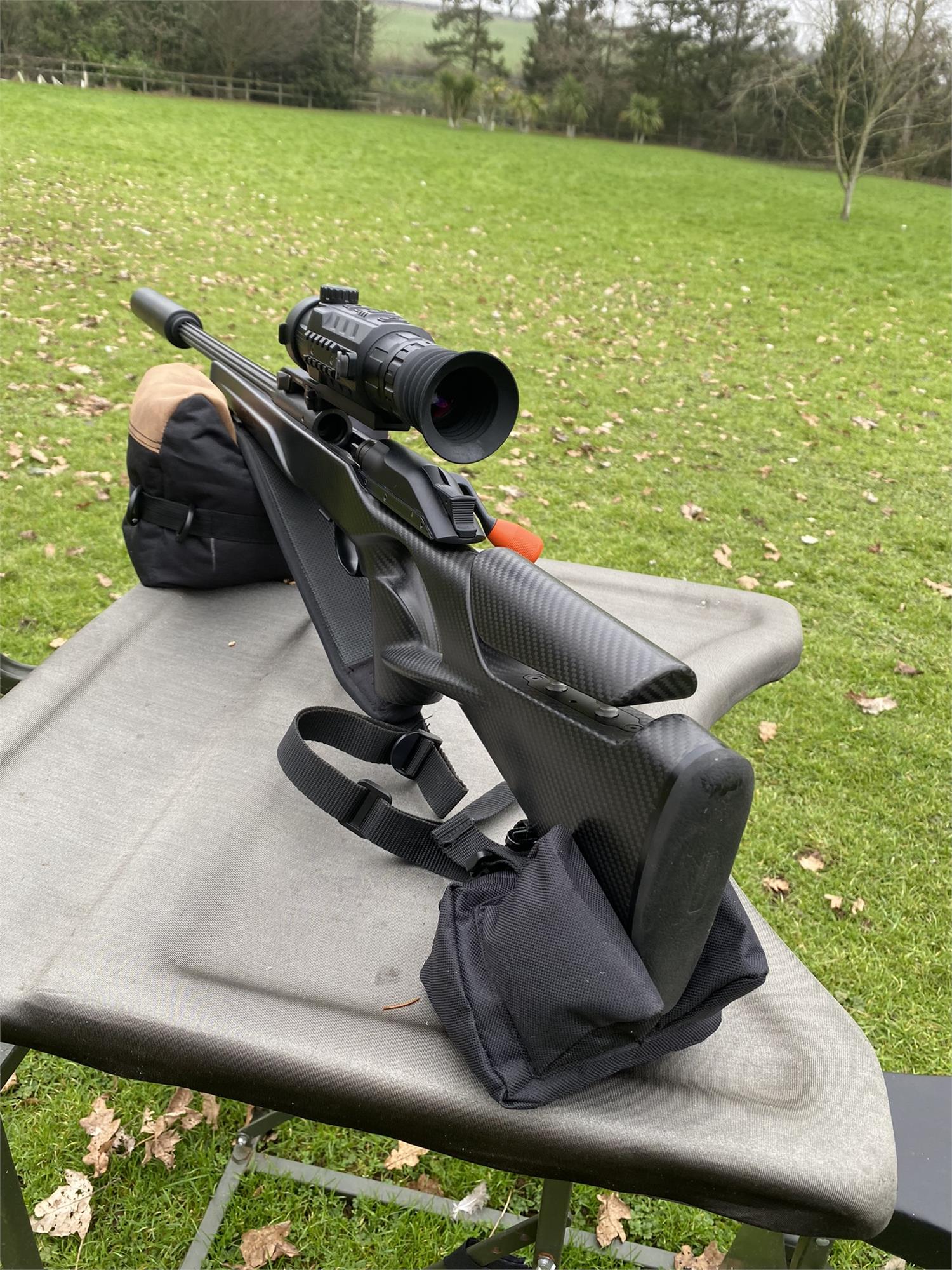 Simon black and brown two-piece rifle rest for stability during shooting, shown unfilled with adjustable support sections.