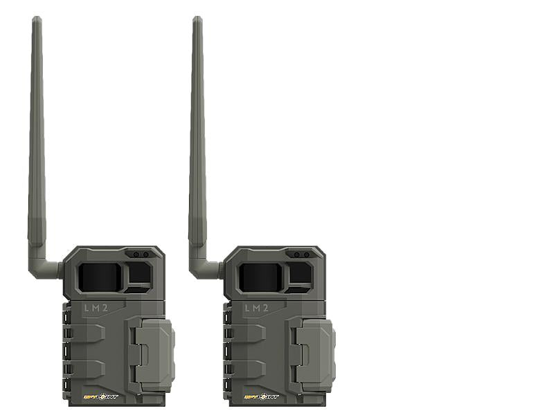 TJACKS SPYPOINT LM2 trail camera mounted outdoors, showing its compact design and lens for wildlife monitoring and security.