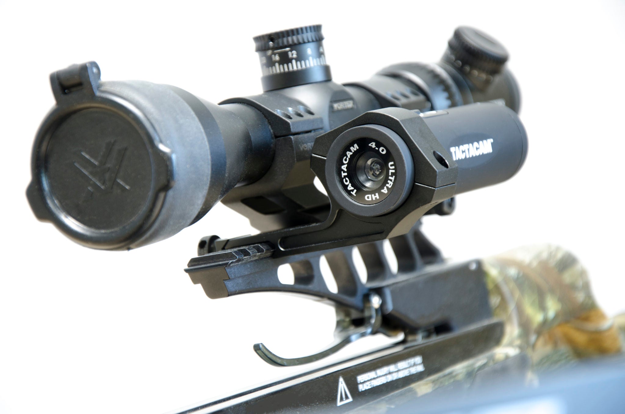 TJACKS TACTACAM under scope rail mount attached to rifle scope for secure camera positioning during hunting or shooting.