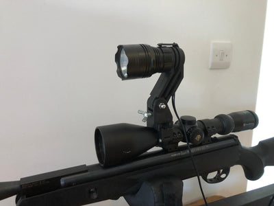 A1 Decoy LED handheld and scope-mounted lamp with 300m+ beam distance, black lightweight design, and adjustable focus.