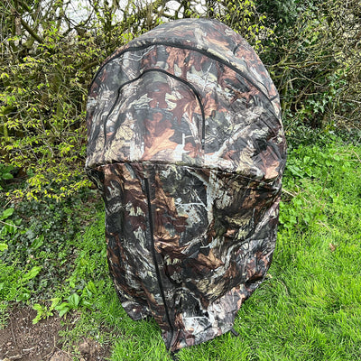Portable Dale 1-man pop-up hide tent set up outdoors, made of durable fabric for hunting or wildlife observation.
