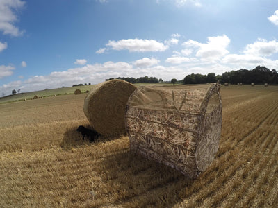 DALE Bale Blind Pop Up Pigeon Hide made of hunting straw, designed for bird shooting and concealment in outdoor settings.