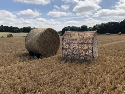 DALE Bale Blind Pop Up Pigeon Hide made of straw for hunting, designed for concealment and easy setup in outdoor fields.