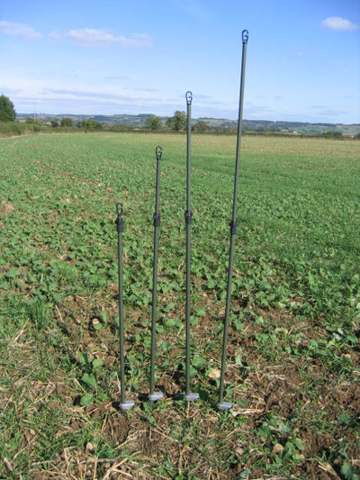 Echo heavy duty hide poles kit with four green durable poles for outdoor hunting or trapping setups.