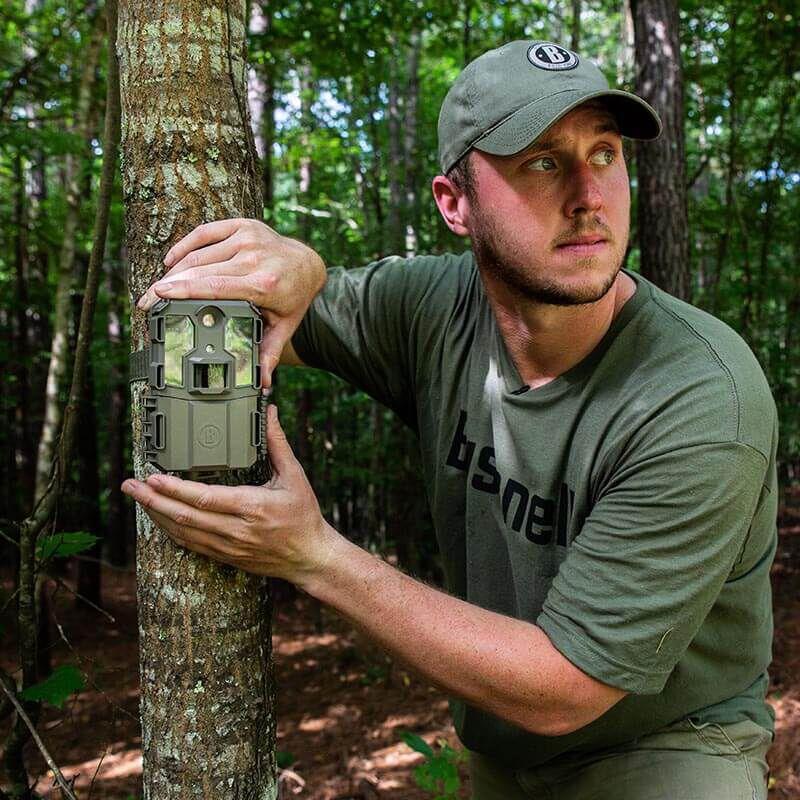 EDGAR Bushnell 20MP Prime L20 Low Glow Trail Camera capturing wildlife with low glow infrared flash in outdoor forest setting.