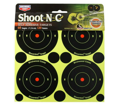 Self-adhesive Birchwood Casey Shoot-N-C targets on a surface, designed for easy outdoor shooting practice, branded by ROTHERY.