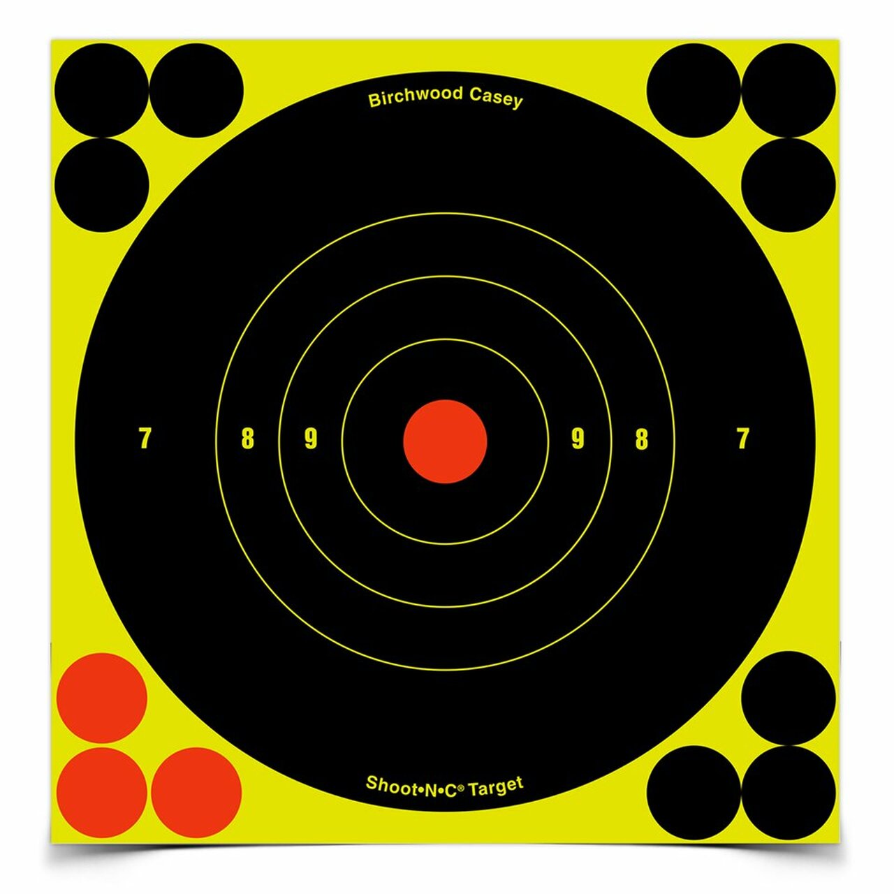 Self-adhesive Birchwood Casey Shoot-N-C targets with high visibility for shooting practice, mounted on a surface.