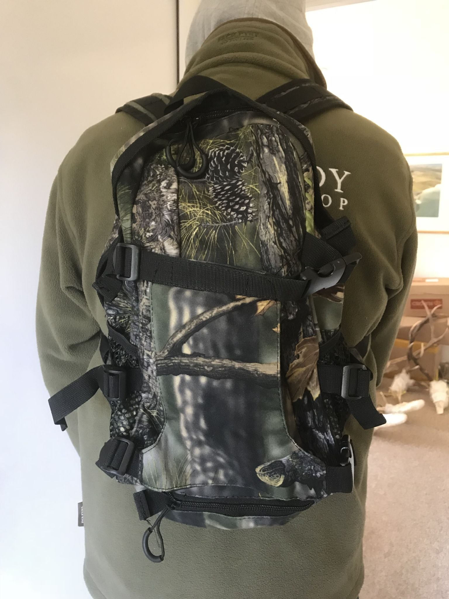 Simon backpack with rifle holder attachment, showing the durable fabric and adjustable straps for secure outdoor carry.