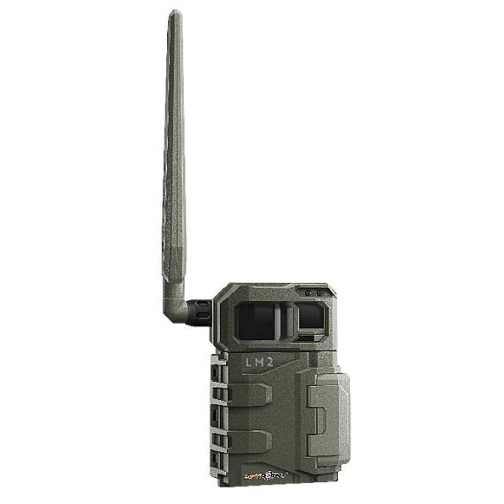 TJACKS SPYPOINT LM2 trail camera mounted outdoors, showcasing its compact design and lens for wildlife monitoring.